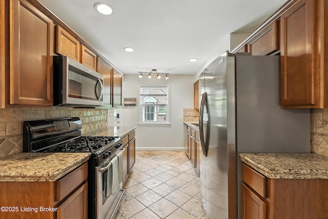 335 Ridgeway Ave, Louisville, KY 40207 - kitchen with appliances with stainless steel finishes, tasteful backsplash, recessed lighting, brown cabinetry, and light stone counters