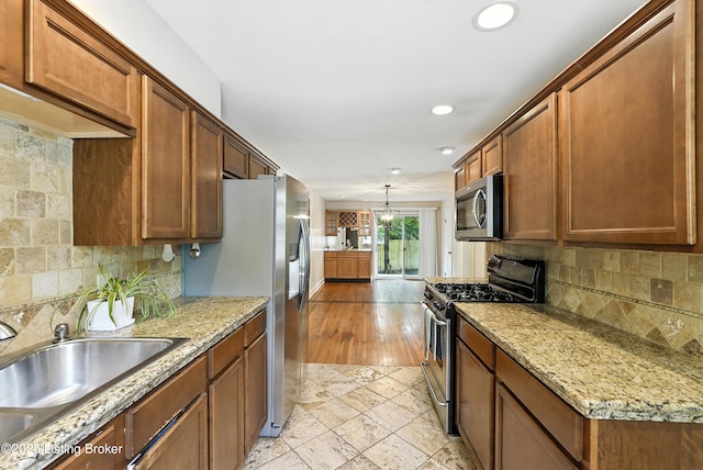 335 Ridgeway Ave, Louisville, KY 40207 - kitchen with appliances with stainless steel finishes, decorative backsplash, recessed lighting, brown cabinets, and light stone counters
