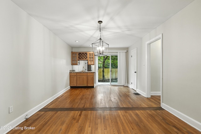 335 Ridgeway Ave, Louisville, KY 40207 - unfurnished dining area with a chandelier and dark wood-style flooring