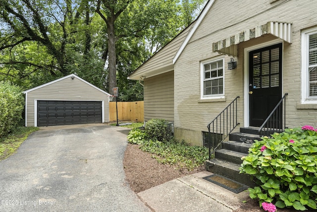 335 Ridgeway Ave, Louisville, KY 40207 - view of side of home with entry steps, a detached garage, brick siding, and an outdoor structure