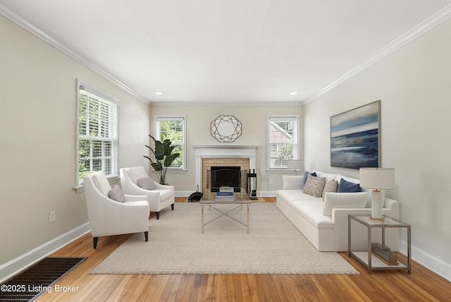 335 Ridgeway Ave, Louisville, KY 40207 - living room featuring wood-type flooring, a fireplace with flush hearth, healthy amount of natural light, recessed lighting, and crown molding