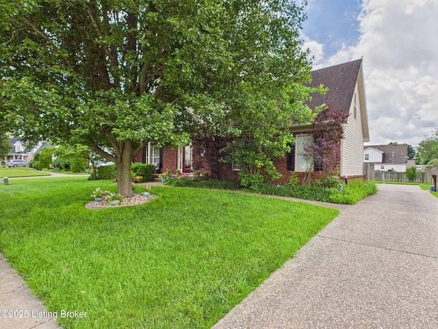 6408 Autumn Oak Way, Louisville, KY 40272 - view of property hidden behind natural elements with roof with shingles, a front lawn, concrete driveway, and brick siding