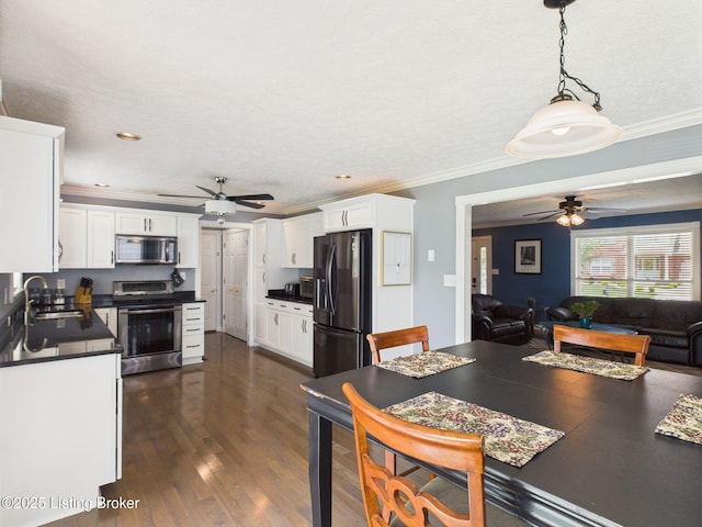 6408 Autumn Oak Way, Louisville, KY 40272 - kitchen featuring stainless steel appliances, ceiling fan, dark countertops, white cabinets, and crown molding
