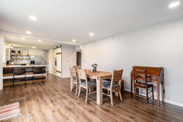 609 Lynn Rd, New Albany, IN 47150 - dining room with recessed lighting, a barn door, and wood finished floors