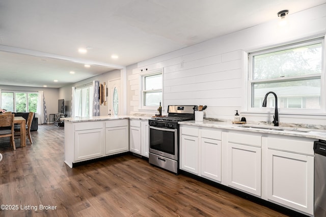 609 Lynn Rd, New Albany, IN 47150 - kitchen featuring appliances with stainless steel finishes, a peninsula, light stone countertops, dark wood-type flooring, and recessed lighting