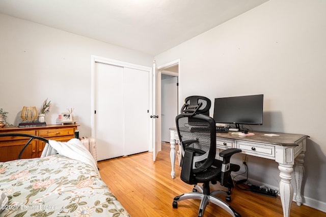 609 Lynn Rd, New Albany, IN 47150 - bedroom featuring light wood-style floors, a desk, a closet, and radiator heating unit