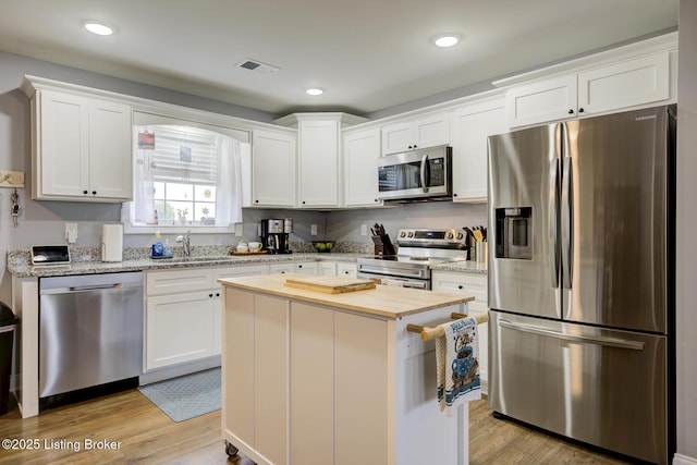 126 Shallow Springs Ct, Bardstown, KY 40004 - kitchen featuring stainless steel appliances, butcher block countertops, white cabinetry, light wood finished floors, and recessed lighting