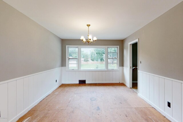 9212 Preston Hwy, Louisville, KY 40229 - unfurnished dining area with wainscoting, a chandelier, and a decorative wall