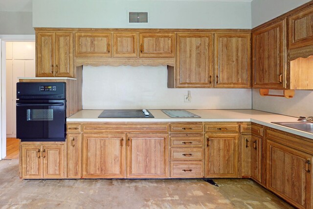 9212 Preston Hwy, Louisville, KY 40229 - kitchen with black appliances, light countertops, and brown cabinetry