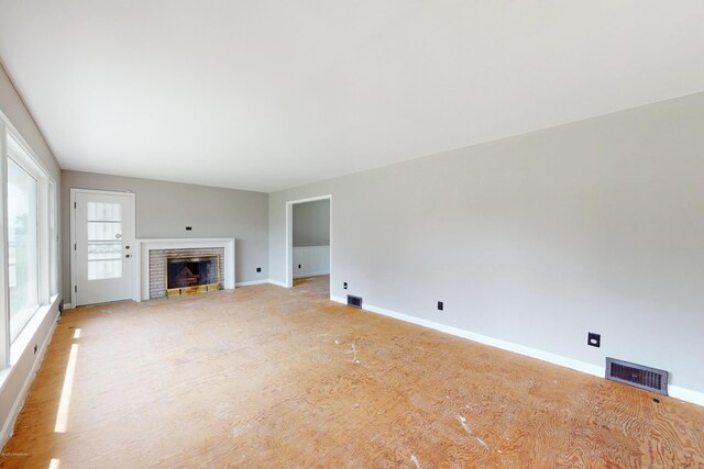 9212 Preston Hwy, Louisville, KY 40229 - unfurnished living room featuring a brick fireplace and baseboards