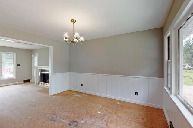 9212 Preston Hwy, Louisville, KY 40229 - unfurnished room with a chandelier, wainscoting, plenty of natural light, and a fireplace