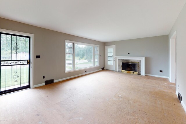 9212 Preston Hwy, Louisville, KY 40229 - unfurnished living room featuring healthy amount of natural light and a fireplace