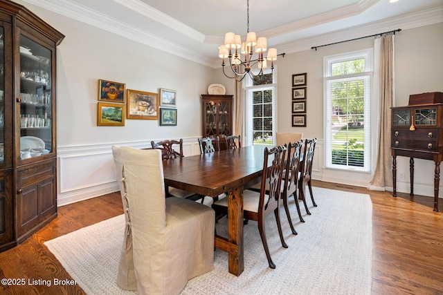 12812 Ridgemoor Dr, Prospect, KY 40059 - dining area with a chandelier, wood finished floors, crown molding, a raised ceiling, and wainscoting
