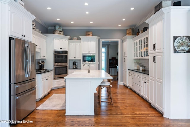 12812 Ridgemoor Dr, Prospect, KY 40059 - kitchen featuring appliances with stainless steel finishes, decorative backsplash, crown molding, recessed lighting, and white cabinetry