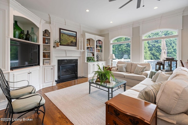 12812 Ridgemoor Dr, Prospect, KY 40059 - living room featuring a ceiling fan, built in shelves, wood finished floors, a fireplace with flush hearth, and ornamental molding