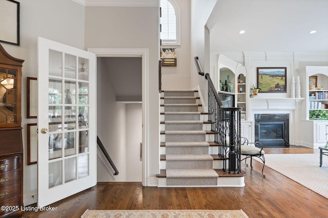 12812 Ridgemoor Dr, Prospect, KY 40059 - stairway with crown molding, wood finished floors, a premium fireplace, built in shelves, and recessed lighting