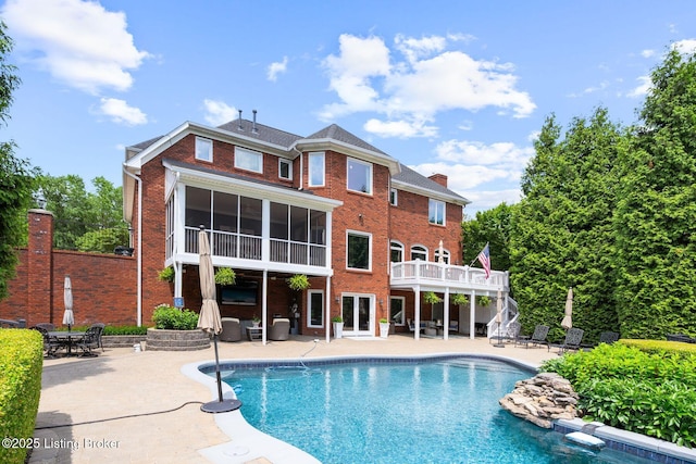 12812 Ridgemoor Dr, Prospect, KY 40059 - outdoor pool featuring a patio, a wooden deck, stairway, and a sunroom