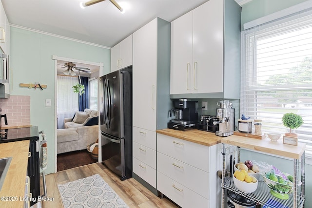 1301 Mark Trail Rd, Louisville, KY 40242 - kitchen featuring freestanding refrigerator, butcher block counters, stainless steel range with electric stovetop, light wood-style flooring, and healthy amount of natural light