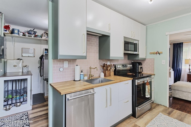 1301 Mark Trail Rd, Louisville, KY 40242 - kitchen featuring stainless steel appliances, butcher block counters, light wood-style flooring, tasteful backsplash, and white cabinets