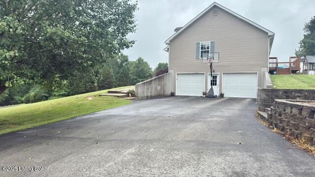360 Grant Ridge Rd, Leitchfield, KY 42754 - view of side of property with asphalt driveway, an attached garage, and a yard