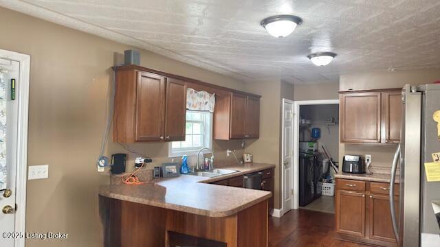 360 Grant Ridge Rd, Leitchfield, KY 42754 - kitchen featuring appliances with stainless steel finishes, light countertops, dark wood-style flooring, and brown cabinetry