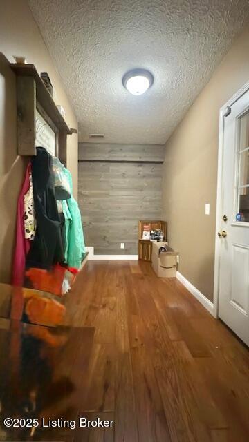 360 Grant Ridge Rd, Leitchfield, KY 42754 - mudroom featuring wood finished floors, wood walls, and a textured ceiling