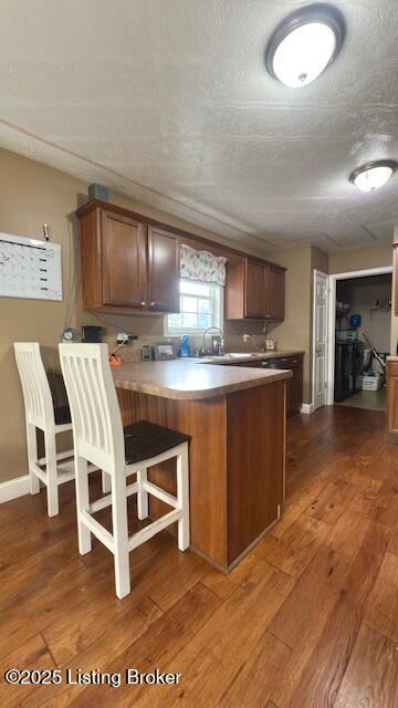 360 Grant Ridge Rd, Leitchfield, KY 42754 - kitchen with a peninsula, dark wood-style flooring, and a breakfast bar