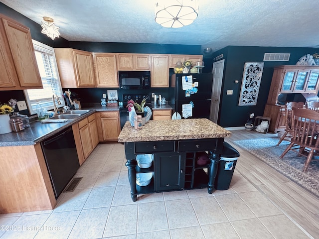 4021/2 Ripy St, Lawrenceburg, KY 40342 - kitchen with black appliances, a textured ceiling, a center island, light tile patterned floors, and light brown cabinets
