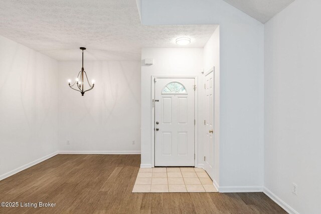 13404 Prospect Glen Way, Prospect, KY 40059 - foyer featuring wood finished floors, a textured ceiling, and a chandelier