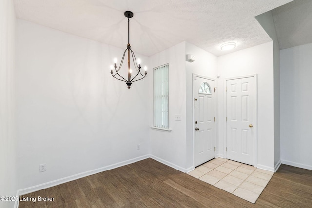 13404 Prospect Glen Way, Prospect, KY 40059 - foyer featuring a chandelier, wood finished floors, and a textured ceiling