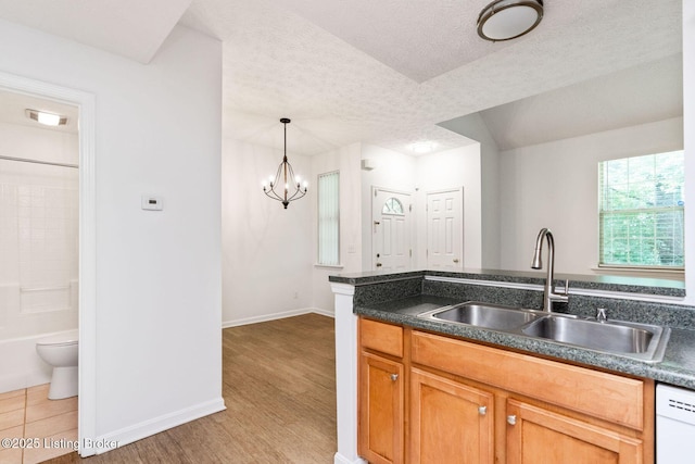 13404 Prospect Glen Way, Prospect, KY 40059 - kitchen with a textured ceiling, white dishwasher, dark countertops, a chandelier, and hanging light fixtures