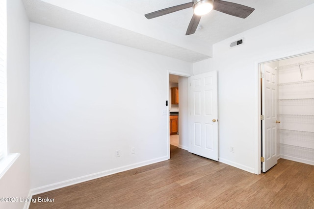 13404 Prospect Glen Way, Prospect, KY 40059 - unfurnished bedroom featuring light wood-style floors, a spacious closet, a closet, and a ceiling fan