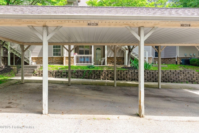 13404 Prospect Glen Way, Prospect, KY 40059 - view of front of house with covered parking, stone siding, a shingled roof, and stairway