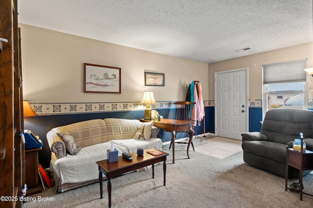 710 Victoria Ct, New Albany, IN 47150 - carpeted living room with a textured ceiling and tile patterned flooring