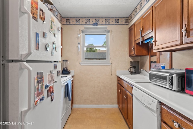 710 Victoria Ct, New Albany, IN 47150 - kitchen with white appliances, brown cabinetry, light countertops, and a textured ceiling