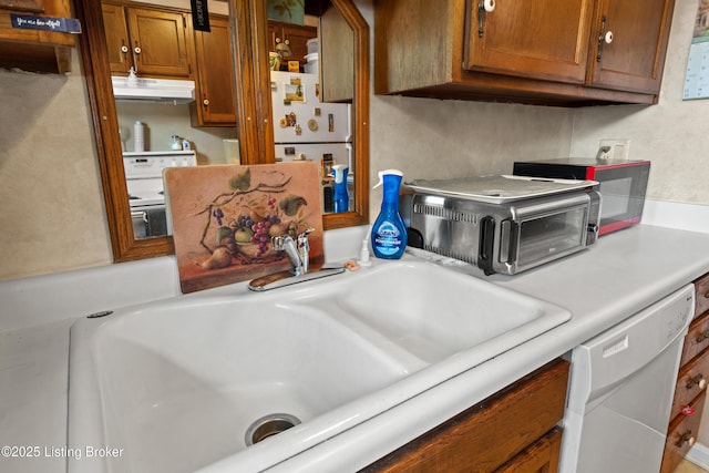 710 Victoria Ct, New Albany, IN 47150 - kitchen featuring white appliances, light countertops, under cabinet range hood, and brown cabinets