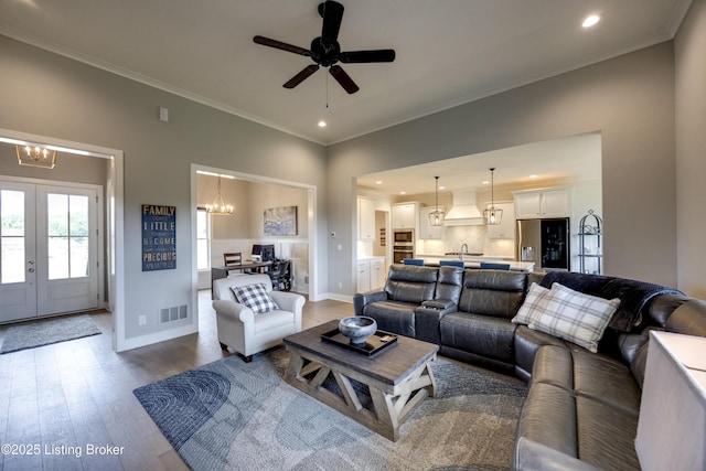 1605 Meremont Ridge Rd, Louisville, KY 40245 - living room with a chandelier, wood finished floors, ornamental molding, recessed lighting, and french doors