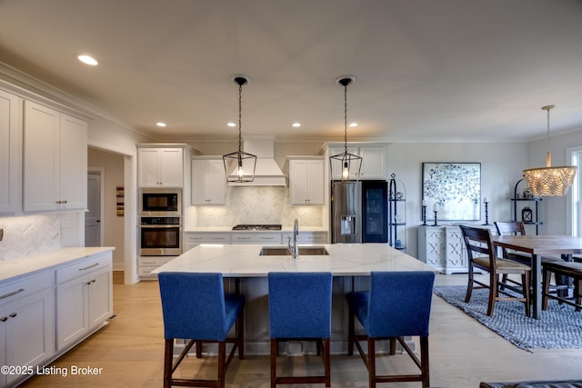 1605 Meremont Ridge Rd, Louisville, KY 40245 - kitchen with appliances with stainless steel finishes, backsplash, white cabinets, light stone counters, and light wood-type flooring