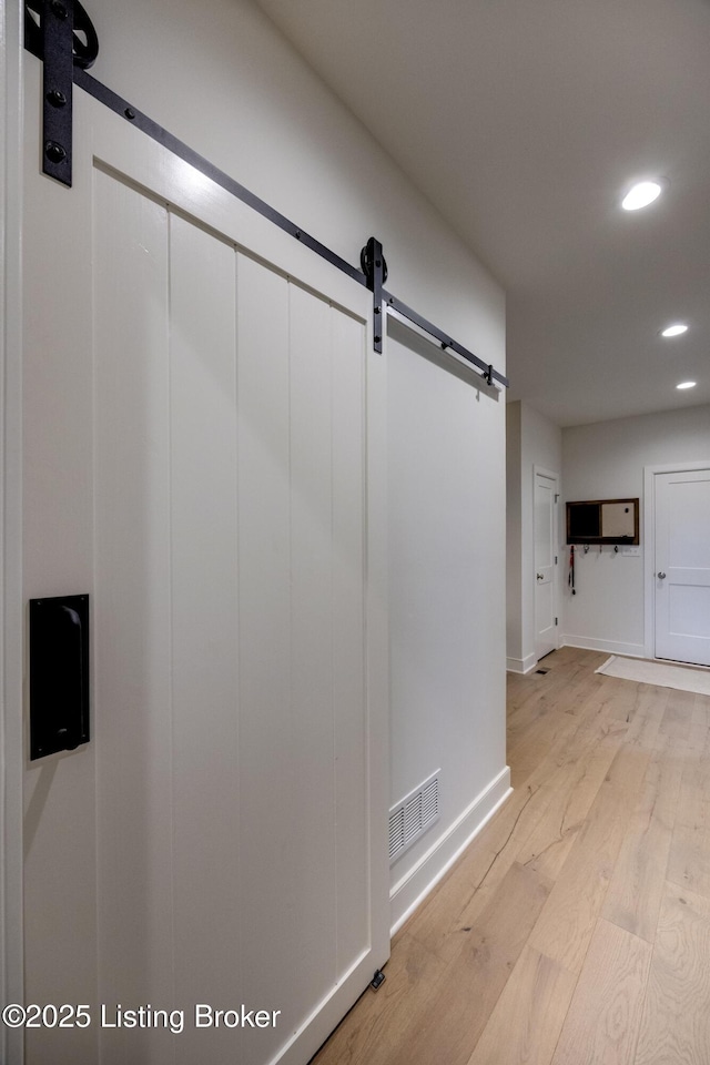 1605 Meremont Ridge Rd, Louisville, KY 40245 - hallway featuring a barn door, light wood-type flooring, and recessed lighting