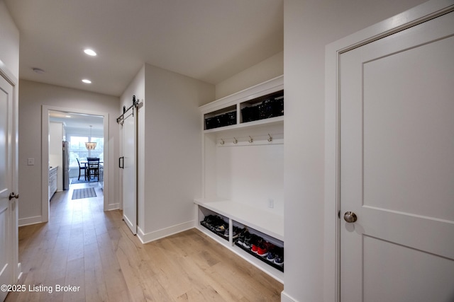 1605 Meremont Ridge Rd, Louisville, KY 40245 - mudroom featuring a barn door, recessed lighting, and light wood-style floors