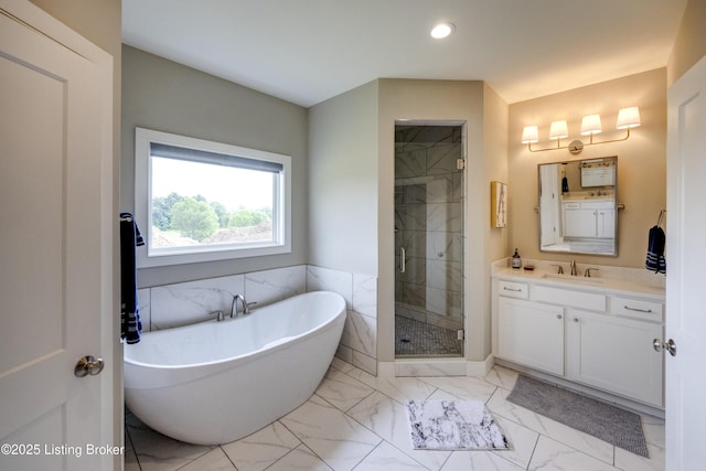 1605 Meremont Ridge Rd, Louisville, KY 40245 - full bathroom with marble look tiles, a soaking tub, vanity, a shower stall, and recessed lighting