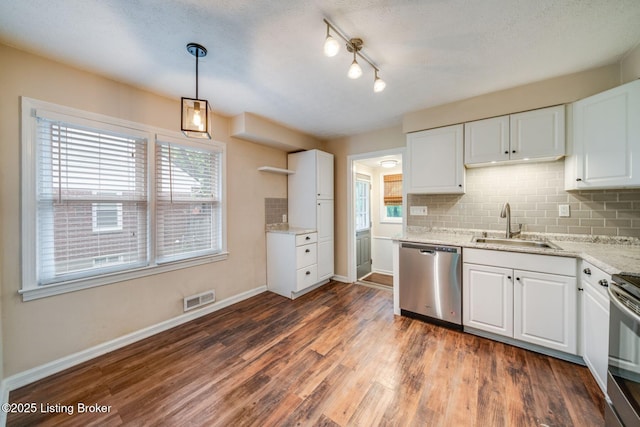 4229 Hillbrook Dr, Louisville, KY 40220 - kitchen featuring appliances with stainless steel finishes, white cabinets, dark wood-style flooring, and decorative backsplash