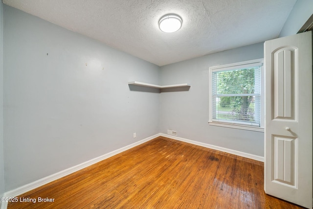 4229 Hillbrook Dr, Louisville, KY 40220 - empty room featuring a textured ceiling and wood finished floors