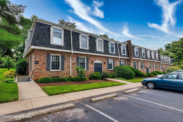 521 Zorn Ave Unit E15, Louisville, KY 40206 - multi unit property with mansard roof, brick siding, and uncovered parking
