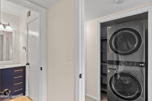 521 Zorn Ave Unit E15, Louisville, KY 40206 - laundry area with estacked washer and dryer and baseboards