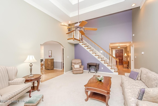 13811 Forest Bend Cir, Louisville, KY 40245 - living area with a towering ceiling, ornamental molding, arched walkways, stairs, and carpet flooring