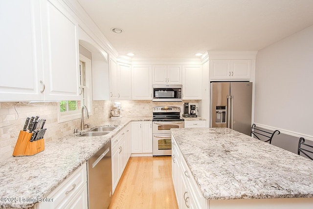 13811 Forest Bend Cir, Louisville, KY 40245 - kitchen with stainless steel appliances, a center island, light stone countertops, light wood-style flooring, and recessed lighting