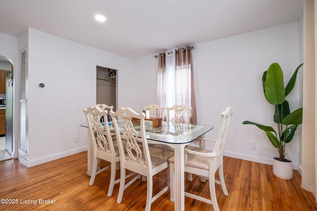 523 Fenley Ave, Louisville, KY 40222 - dining room featuring light wood-style floors, arched walkways, and recessed lighting