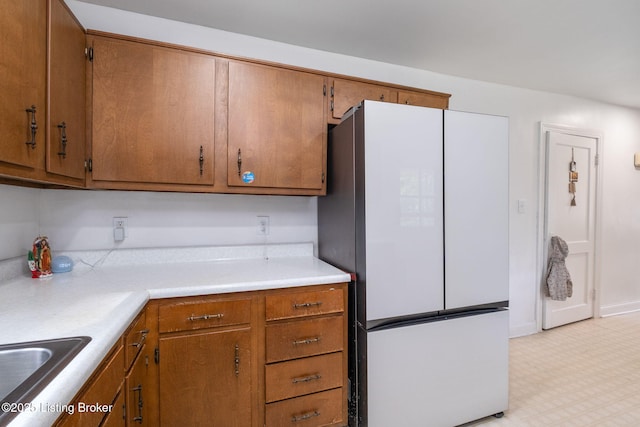 523 Fenley Ave, Louisville, KY 40222 - kitchen featuring freestanding refrigerator and brown cabinetry