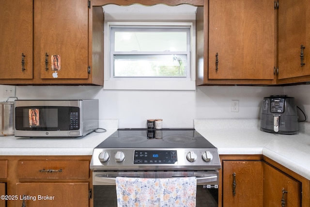 523 Fenley Ave, Louisville, KY 40222 - kitchen featuring stainless steel appliances, light countertops, and brown cabinetry